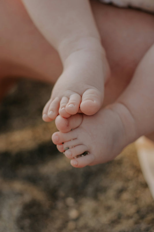 a close up of a person holding a baby's hand